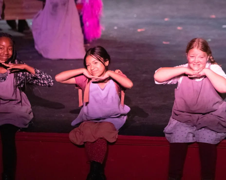 a group of girls sitting on a bench