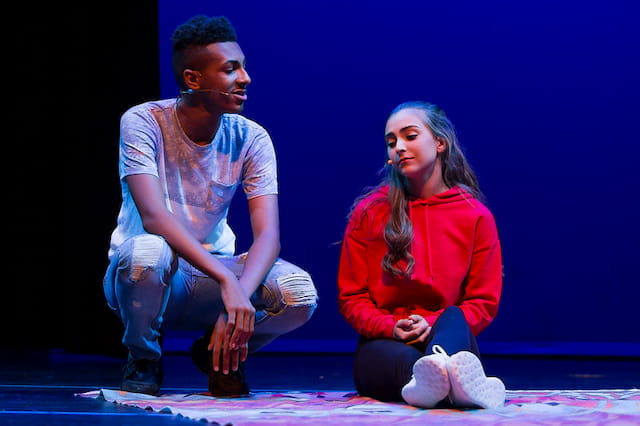 a man and a woman sitting on the floor