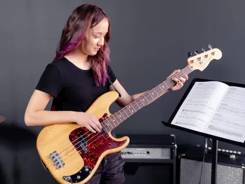 a woman playing a guitar