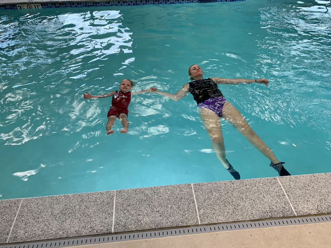 a group of people jumping into a pool