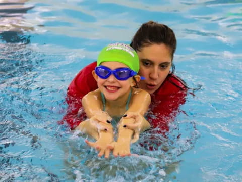 a couple of kids in a pool