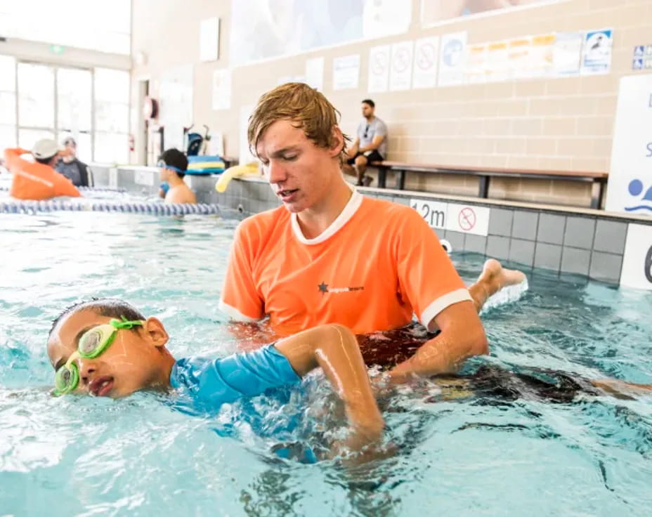 a person and a boy in a pool