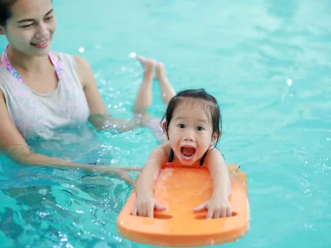 a person and a child in a pool