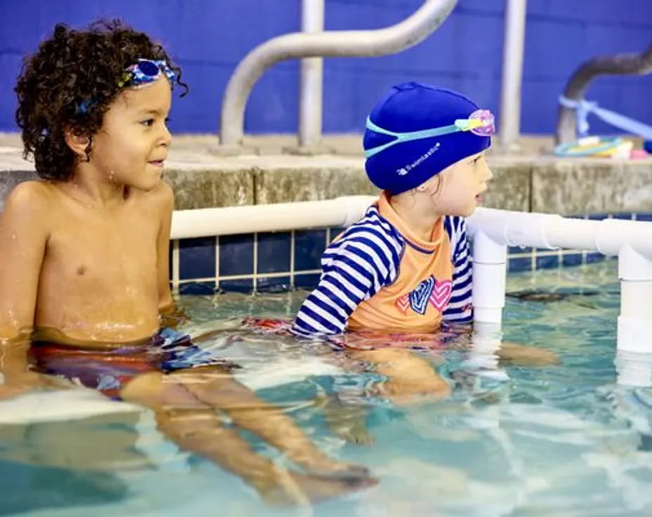 a couple of children in a pool