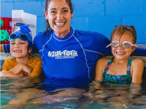 a man and two children in a pool