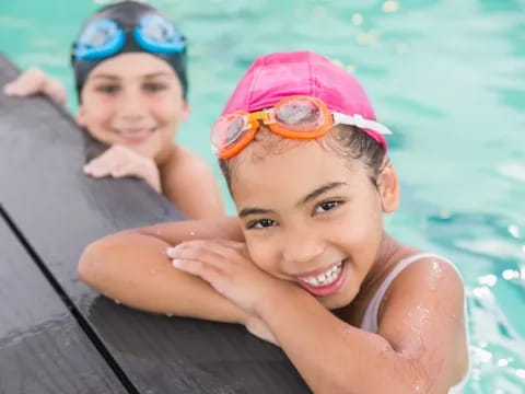 a couple of kids in a pool