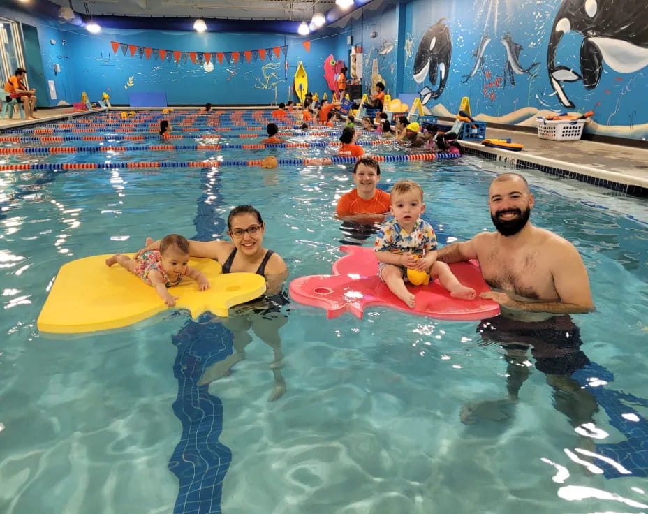 a man and two children in a pool