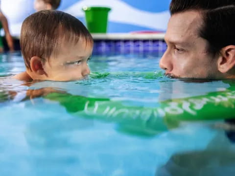 a man and a child in a pool