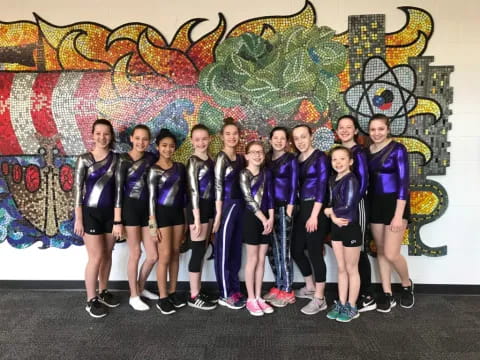 a group of girls in purple shirts