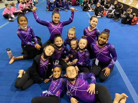a group of girls in purple shirts
