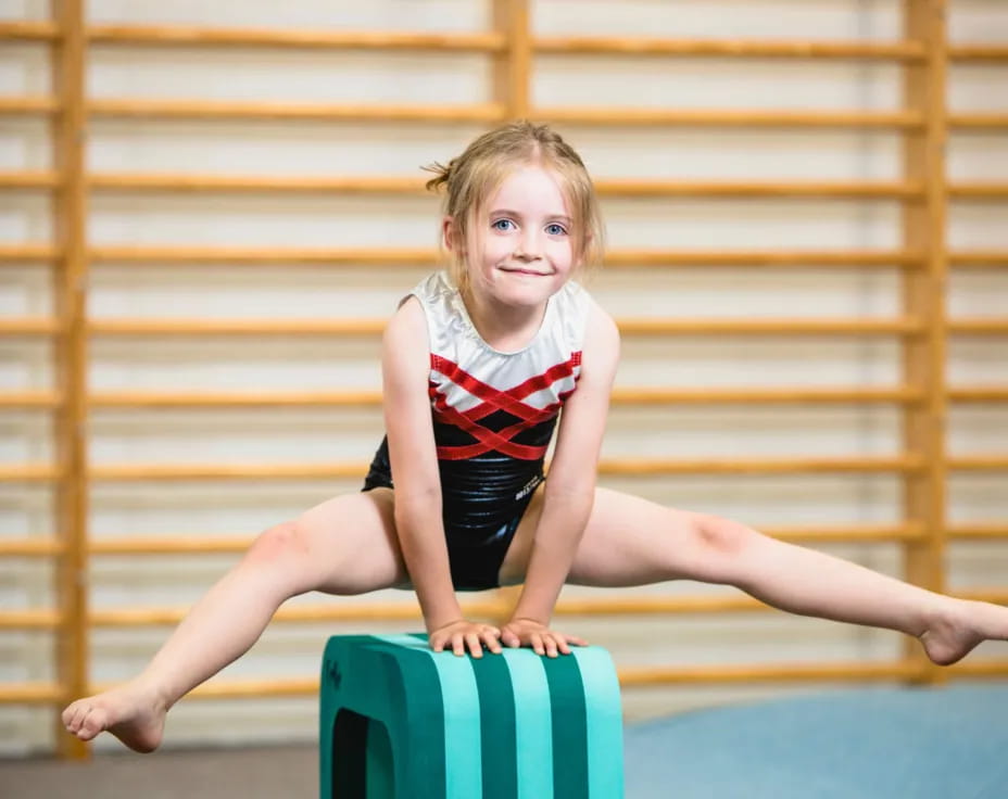a girl sitting on a suitcase
