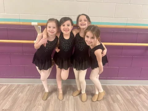 a group of girls in black dresses