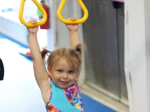 a girl holding a yellow hoop
