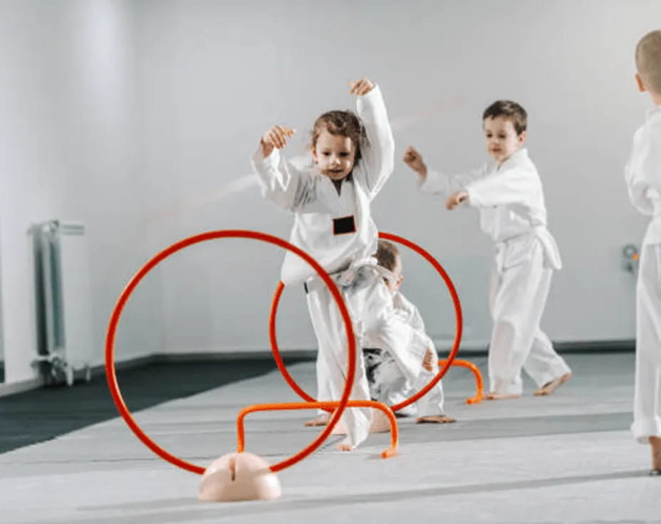 a group of kids in karate uniforms