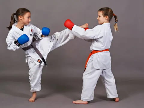 two girls in karate uniforms