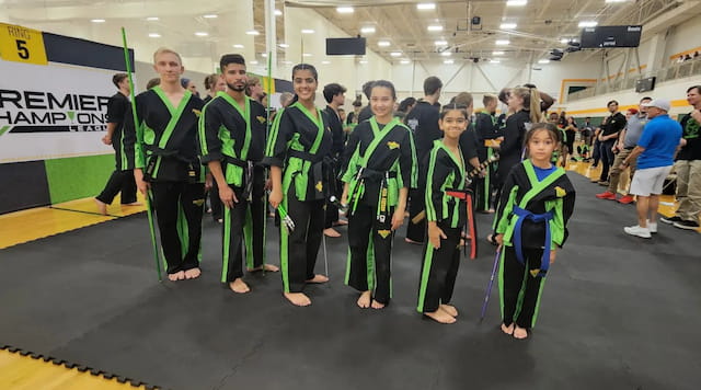a group of people in green jumpsuits