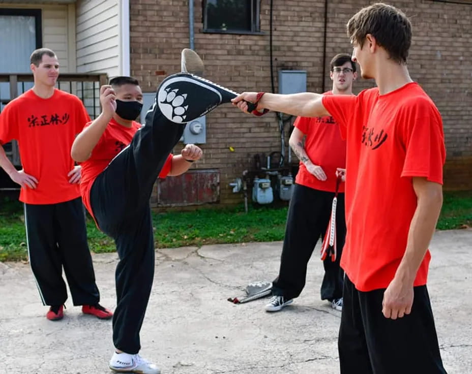 a group of men in red shirts