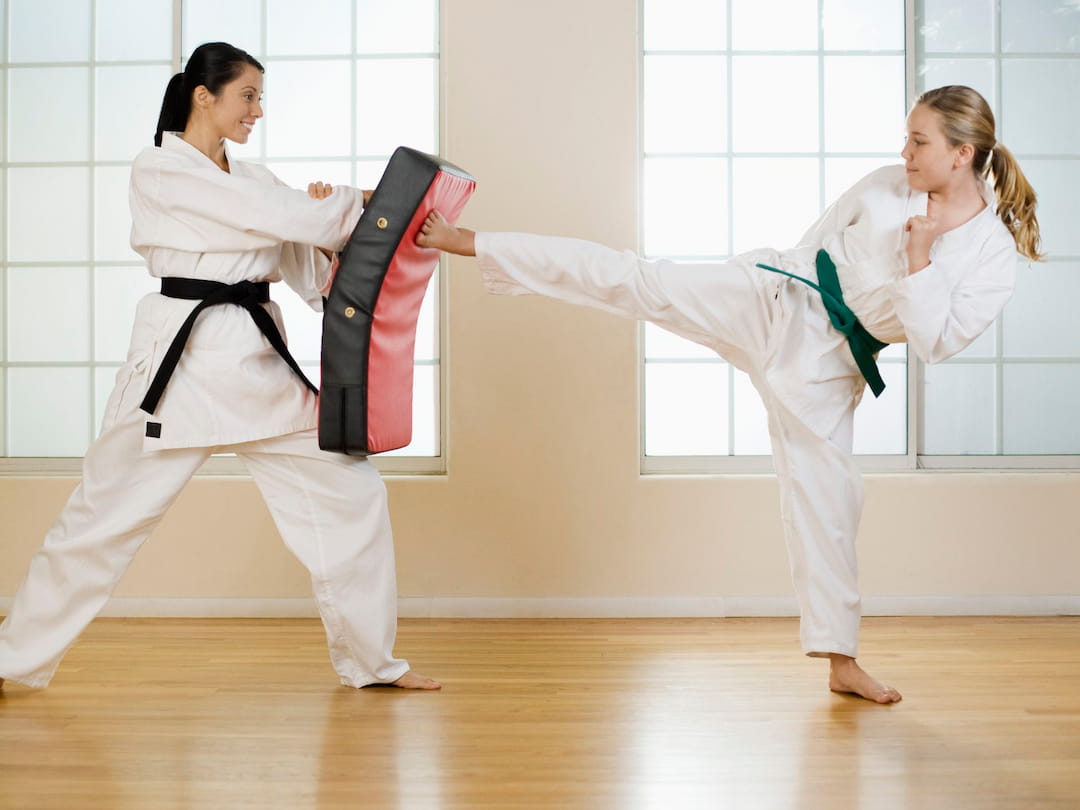 a couple of women in karate uniforms