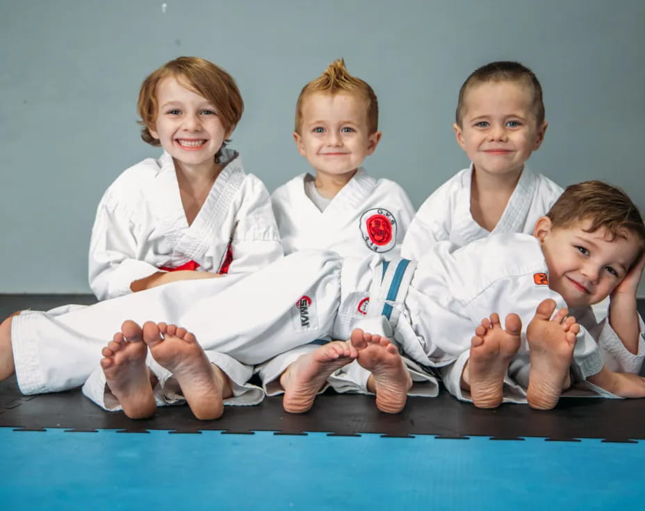 a group of kids in karate uniforms