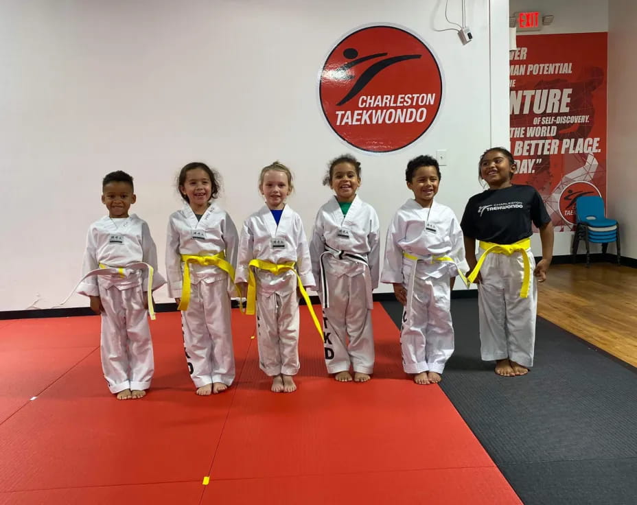 a group of kids in karate uniforms
