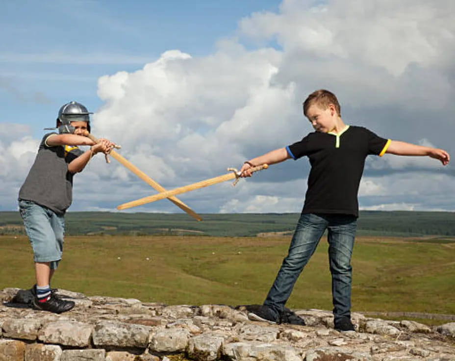two men holding a bow and arrow