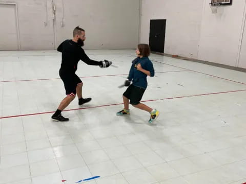a man and a boy playing hockey