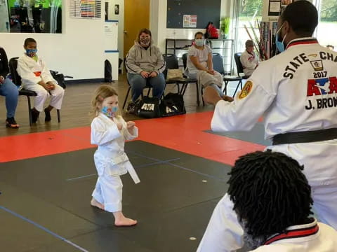 a child in a white outfit