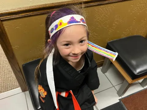 a girl wearing a colorful hat