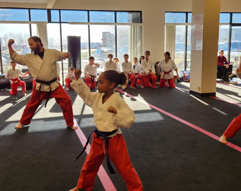 a boy and girl in karate uniforms