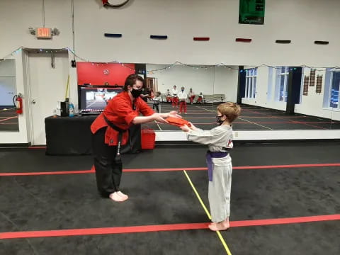 a person and a boy in a gym