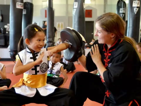 a person and a girl in a gym