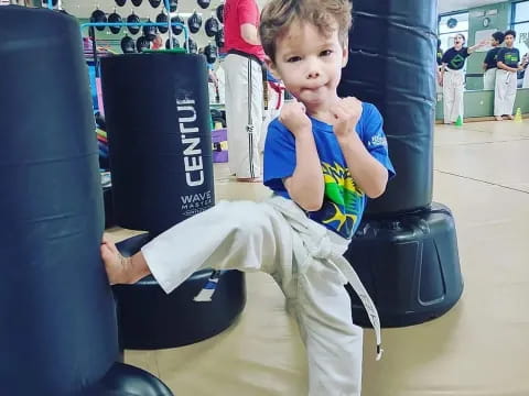 a boy sitting on a gym chair