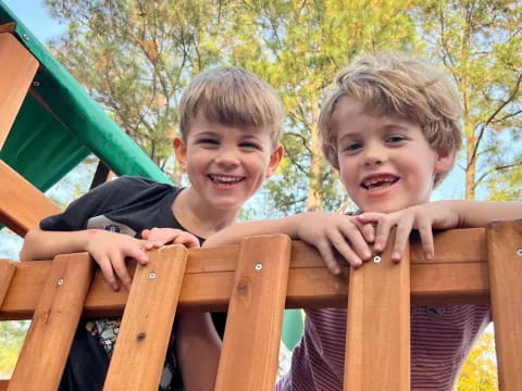 two boys sitting on a bench
