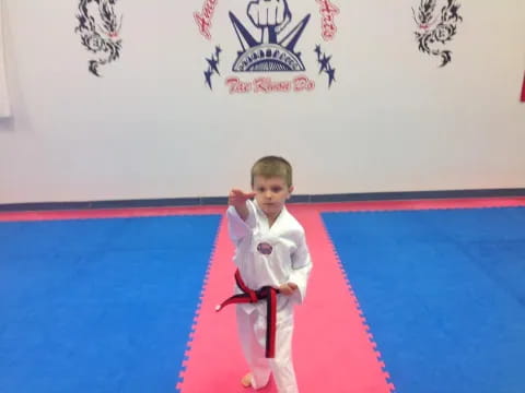 a boy in a karate uniform