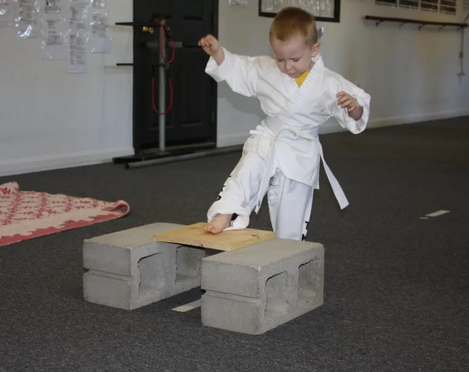 a boy in a white suit