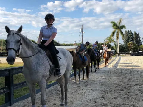 a group of people riding horses