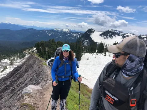 a man and woman on a mountain
