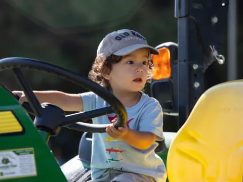 a young boy riding a scooter