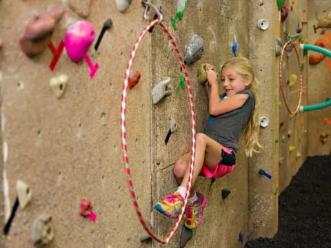 a girl climbing a rock wall