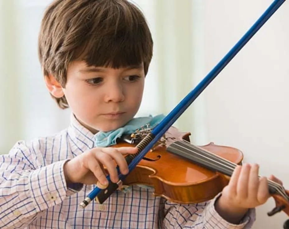 a boy playing a violin