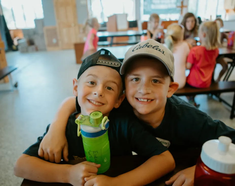 two boys sitting at a table