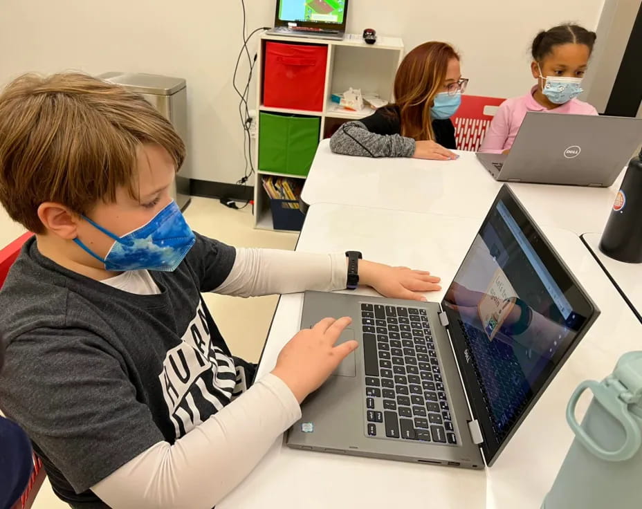 a boy using a laptop