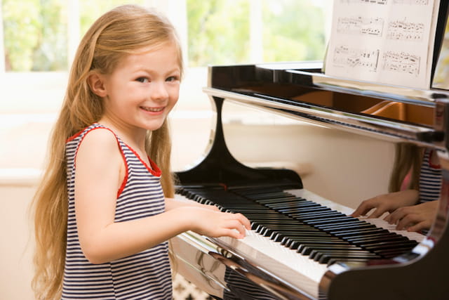 a girl playing a piano