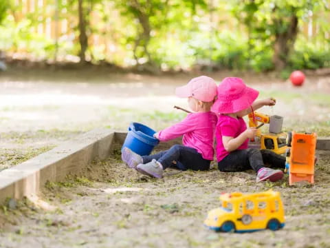 two children playing in the sand