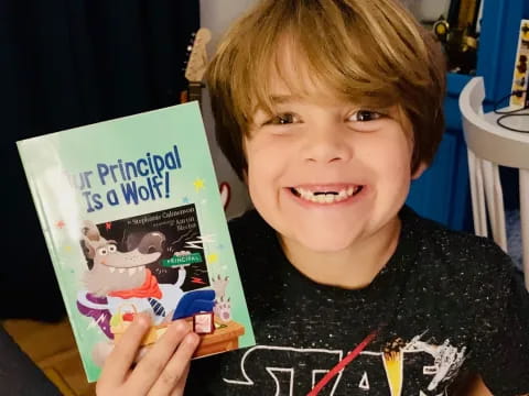 a boy holding a book
