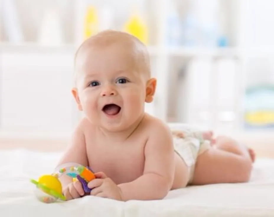 a baby lying on a bed