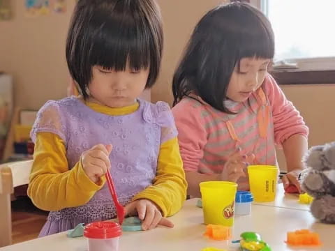 a couple of young girls painting
