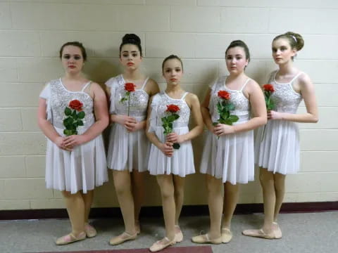 a group of girls in white dresses