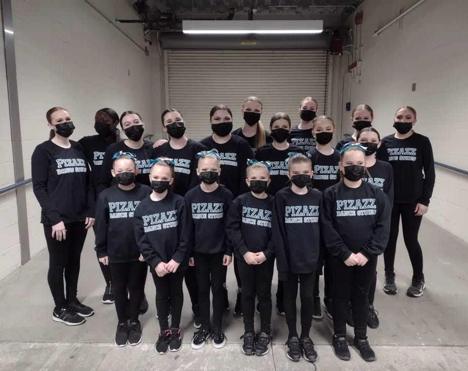 a group of people in black shirts