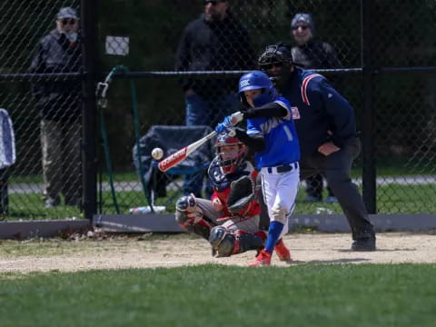 a baseball player swings a bat